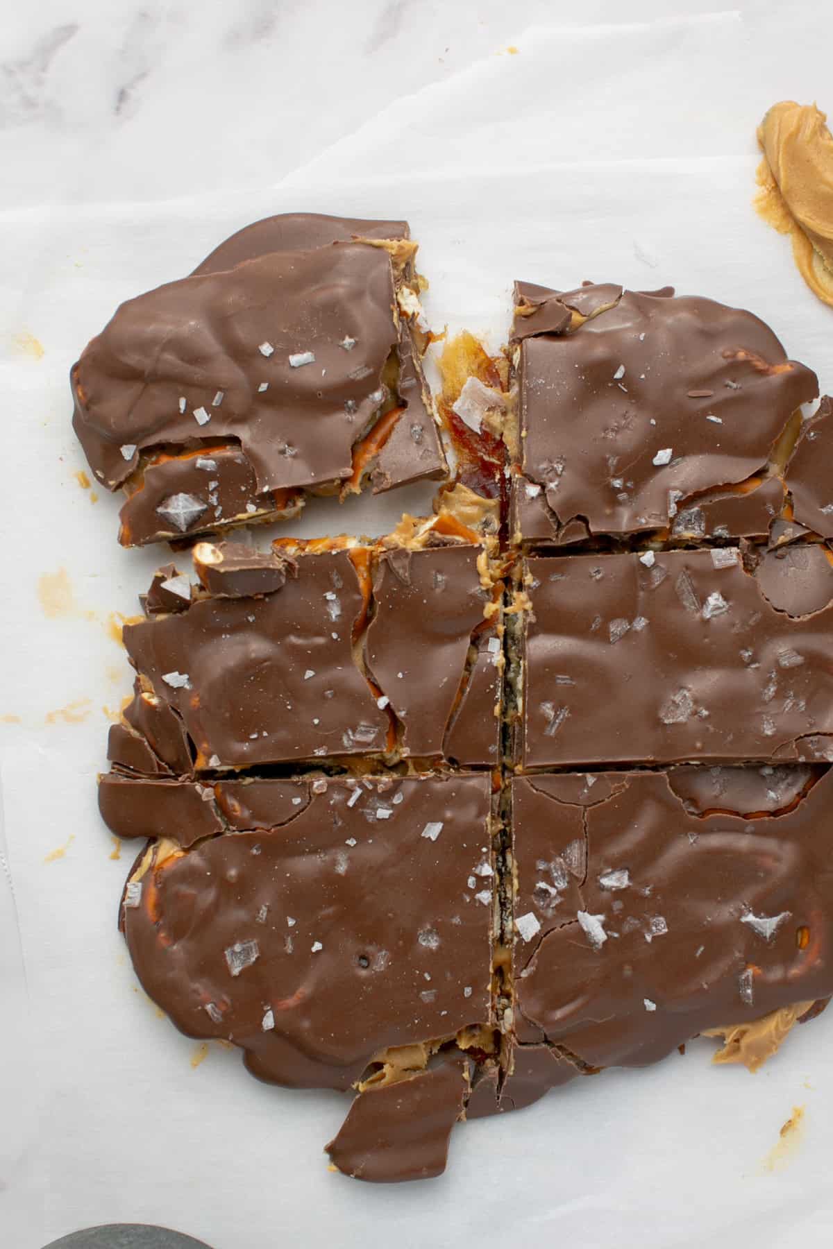 Chocolate Peanut Butter Pretzel Date Bark cut into squares.
