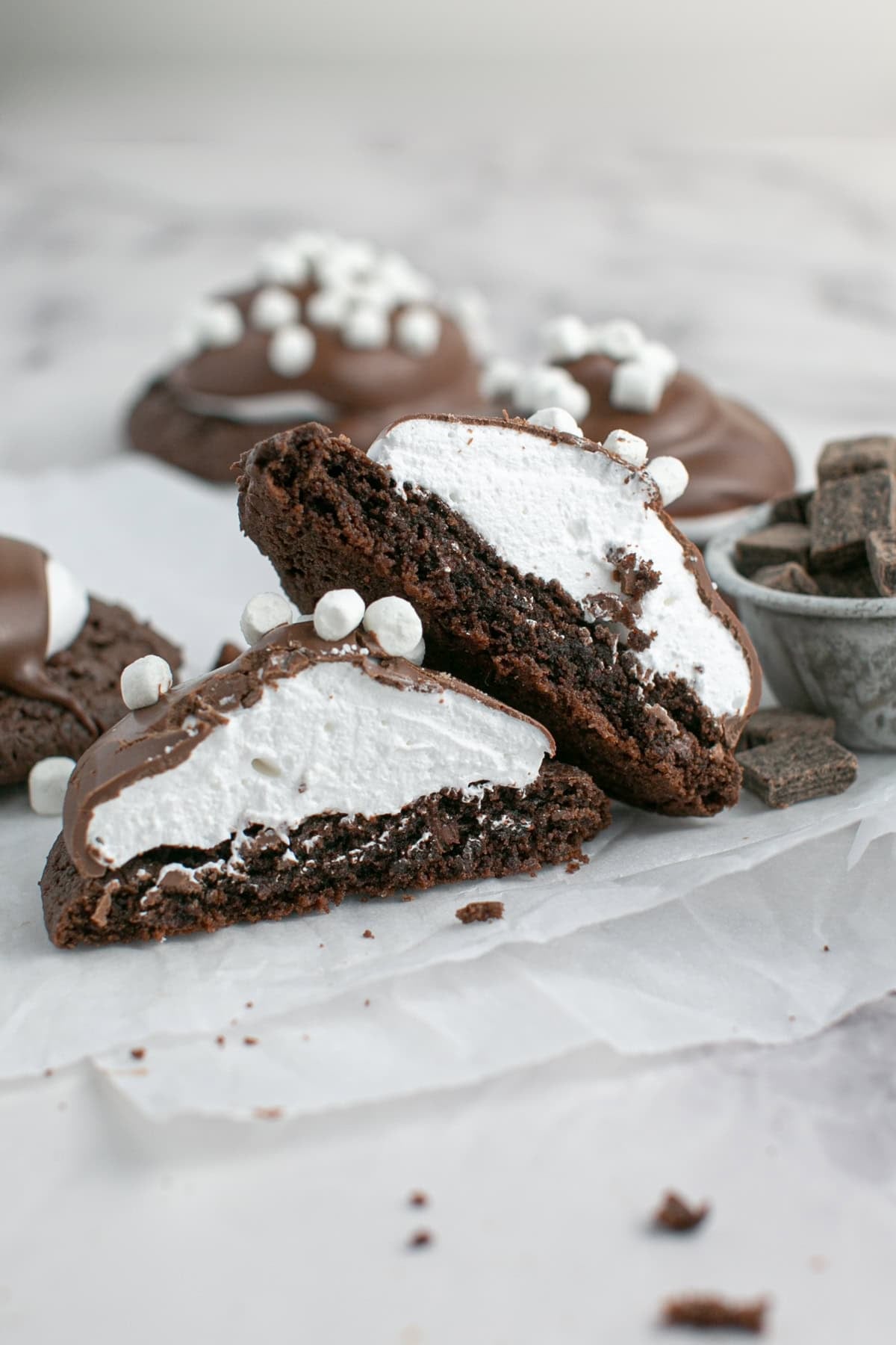 Hot Chocolate Marshmallow Cookie with cake mix cookies cut in half. 