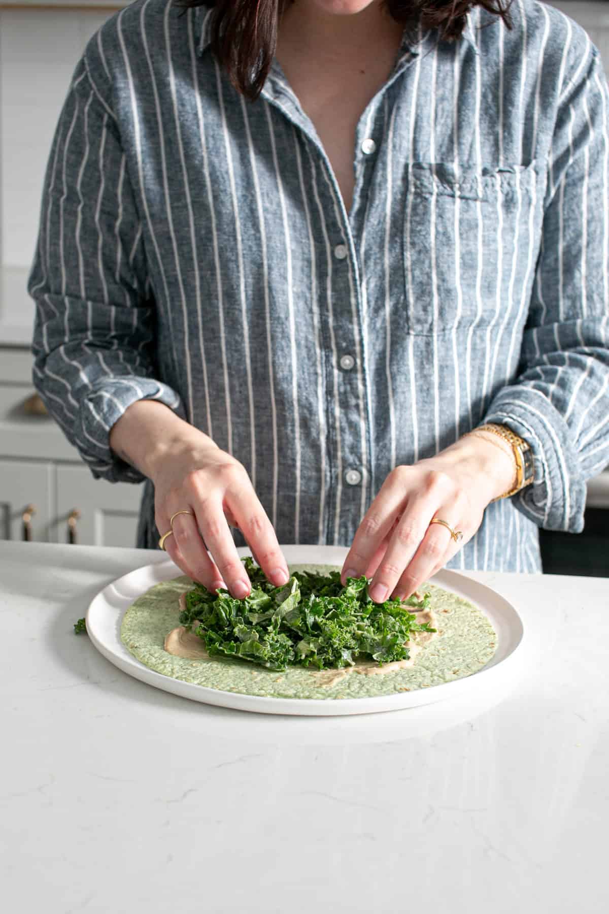 Making a chickpea kale wrap.